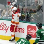 
              Calgary Flames left wing Johnny Gaudreau (13) celebrates after scoring as Dallas Stars' Joel Hanley (44) and Jani Hakanpaa (2) skate past in the third period of an NHL hockey game in Dallas, Tuesday, Feb. 1, 2022. (AP Photo/Tony Gutierrez)
            