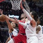 
              Chicago Bulls' Zach LaVine (8) drives to the basket and is fouled by Memphis Grizzlies' Kyle Anderson (1) as Steven Adams and Ja Morant also defend during the first half of an NBA basketball game Saturday, Feb. 26, 2022, in Chicago. (AP Photo/Charles Rex Arbogast)
            