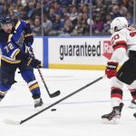 
              St. Louis Blues defenseman Justin Faulk (72) scores a goal as New Jersey Devils center Michael McLeod (20) attempts to block during the second period of an NHL hockey game Thursday, Feb. 10, 2022, in St. Louis. (AP Photo/Joe Puetz)
            