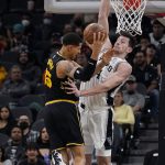 
              Golden State Warriors forward Juan Toscano-Anderson (95) drives to the basket against San Antonio Spurs forward Drew Eubanks (14) during the second half of an NBA basketball game, Tuesday, Feb. 1, 2022, in San Antonio. (AP Photo/Eric Gay)
            