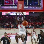 
              Houston guard Taze Moore (4) dunks the ball against Central Florida during the second half of an NCAA college basketball game Thursday, Feb. 17, 2022, in Houston. (AP Photo/Justin Rex)
            
