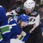 
              Arizona Coyotes' Lawson Crouse, right, and Vancouver Canucks' Kyle Burroughs fight during the third period of an NHL hockey game Tuesday, Feb. 8, 2022, in Vancouver, British Columbia. (Darryl Dyck/The Canadian Press via AP)
            