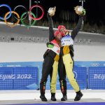 
              Gold medal finishers Katharina Hennig, of Germany, left, and Victoria Carl, of Germany, celebrate during a venue ceremony after the women's team sprint classic cross-country skiing competition at the 2022 Winter Olympics, Wednesday, Feb. 16, 2022, in Zhangjiakou, China. (AP Photo/Aaron Favila)
            