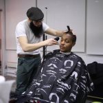 
              In a photo provided by Benji Weintraub, barber Levi Aronow gives an unidentified guest a haircut during Super Soul Party's 2019 Super Bowl party for homeless people Feb. 3, 2019, in New York. Super Soul Party will have parties in at least 35 cities for the Super Bowl between the Los Angeles Rams and Cincinnati Bengals. (Benji Weintraub via AP)
            