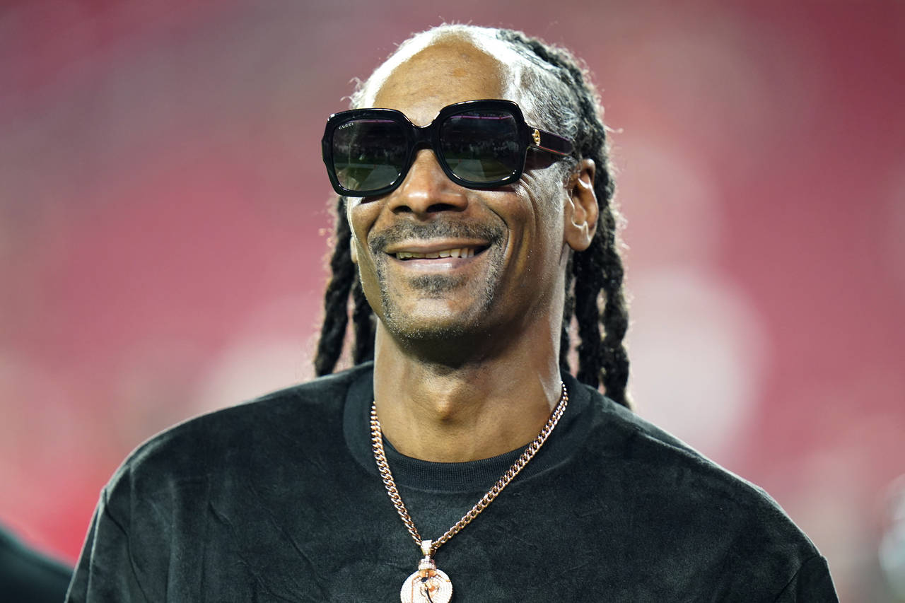FILE - Entertainer Snoop Dogg walks on the field before an NFL football game between the Tampa Bay ...