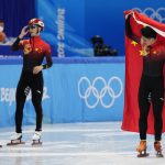 
              Ren Ziwei, right, of China, celebrates after winning the men's 1,000-meter final during the short track speedskating competition at the 2022 Winter Olympics, Monday, Feb. 7, 2022, in Beijing. (AP Photo/Bernat Armangue)
            