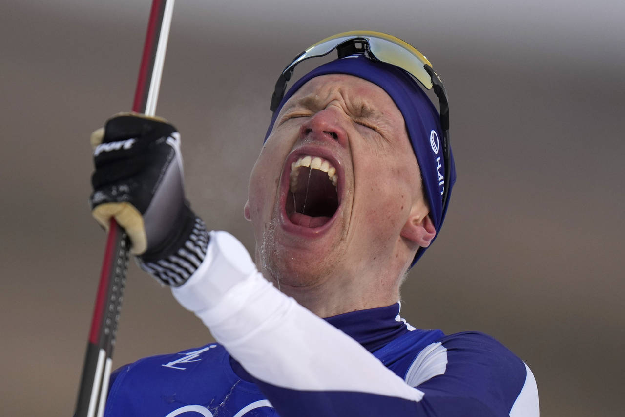 Iivo Niskanen, of Finland, celebrates after finishing the men's 15km classic cross-country skiing c...
