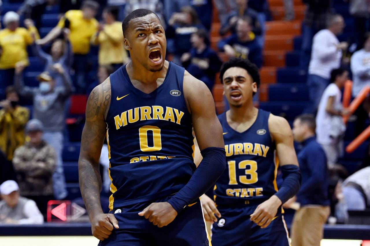 Murray State forward K.J. Williams (0) and guard Carter Collins (13) celebrate after they defeated ...