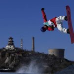 
              Takeru Otsuka of Japan competes during the men's snowboard big air qualifications of the 2022 Winter Olympics, Monday, Feb. 14, 2022, in Beijing. (AP Photo/Jae C. Hong)
            