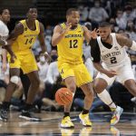 
              Penn State guard Myles Dread (2) pokes the ball away from Michigan guard DeVante' Jones (12) during an NCAA college basketball game Tuesday, Feb. 8, 2022, in State College, Pa. (Noah Riffe/Centre Daily Times via AP)
            