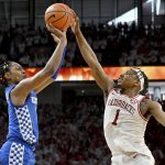 
              Arkansas guard JD Notae (1) blocks a three point shot attempt by Kentucky guard TyTy Washington Jr. (3) with 8.8 seconds left in the the second half of an NCAA college basketball game Saturday, Feb. 26, 2022, in Fayetteville, Ark. (AP Photo/Michael Woods)
            