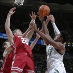 
              Michigan State's Julius Marble, right, and Wisconsin's Ben Carlson (20) reach for a rebound during the first half of an NCAA college basketball game, Tuesday, Feb. 8, 2022, in East Lansing, Mich. (AP Photo/Al Goldis)
            