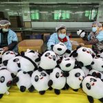 
              Workers at a factory manufacture Bing Dwen Dwen stuffed dolls, the mascot of 2022 Winter Olympics, in Jinjiang city in southeastern China's Fujian province Tuesday, Feb. 8, 2022. (Chinatopix via AP)
            