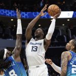 
              Memphis Grizzlies forward Jaren Jackson Jr. (13) shoots the ball over Charlotte Hornets center Montrezl Harrell (8) during the first half of an NBA basketball game in Charlotte, N.C., Saturday, Feb. 12, 2022. (AP Photo/Jacob Kupferman)
            