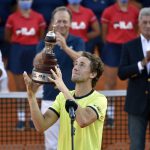 
              Casper Ruud of Norway holds the trophy after winning the Argentina Open tennis singles final, at Guillermo Vilas Stadium in Buenos Aires, Argentina, Sunday, Feb. 13, 2022. (AP Photo/Gustavo Garello)
            