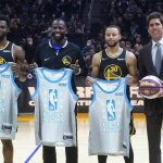 
              Golden State Warriors' Andrew Wiggins, Draymond Green, Stephen Curry and general manager Bob Myers, from left, pose while the players were presented All-Star Game jerseys, before the team's NBA basketball game against the Denver Nuggets in San Francisco, Wednesday, Feb. 16, 2022. (AP Photo/Jeff Chiu)
            