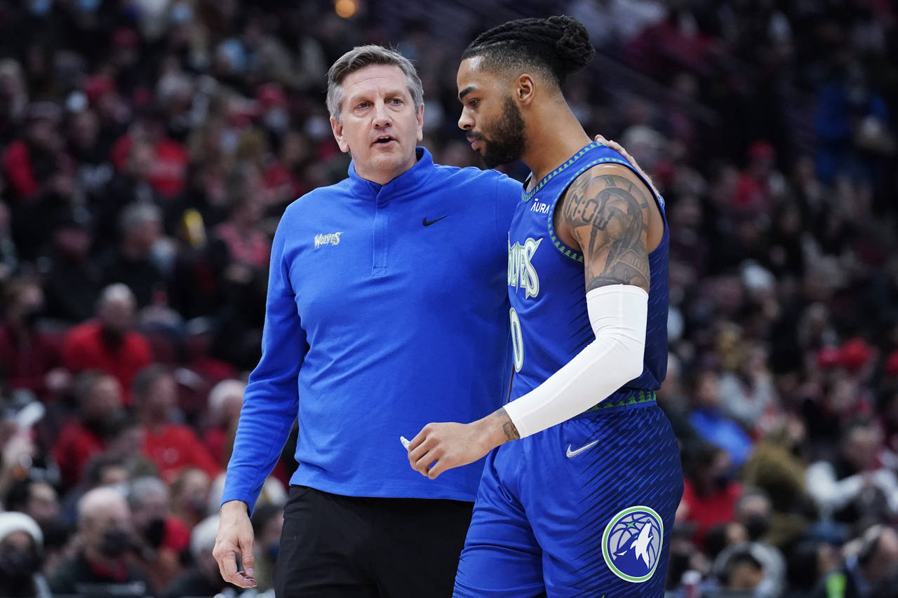 Minnesota Timberwolves head coach Chris Finch, left, talks with guard D'Angelo Russell during the f...