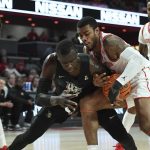 
              Houston forward Reggie Chaney (32) and Central Florida forward Cheikh Mbacke Diong (34) fight for control of the ball during the first half of an NCAA college basketball game Thursday, Feb. 17, 2022, in Houston. (AP Photo/Justin Rex)
            