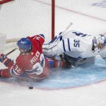 
              Montreal Canadiens' Rem Potlick, left, collides with Toronto Maple Leafs' goaltender Petr Mrazek during first-period NHL hockey game action in Montreal, Monday, Feb. 21, 2022. (Graham Hughes/The Canadian Press via AP)
            
