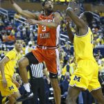 
              Illinois guard Jacob Grandison (3) takes a shot against Michigan forward Moussa Diabate, right, during the first half of an NCAA college basketball game Sunday, Feb. 27, 2022, in Ann Arbor, Mich. (AP Photo/Duane Burleson)
            