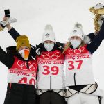 
              Gold medalist Ursa Bogataj, of Slovenia, center, celebrates with silver medalist Katharina Althaus, of Germany, left, and Nika Kriznar, during the flower ceremony for the women's normal hill individual ski jumping event at the 2022 Winter Olympics, Saturday, Feb. 5, 2022, in Zhangjiakou, China. (AP Photo/Andrew Medichini)
            