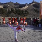 
              FILE - Wu Jingyu, China's Taekwondo Olympic champion, poses with a kick before taking part in the torch relay for the 2022 Winter Olympics at the Badaling Great Wall on the outskirts of Beijing, China, on Feb. 3, 2022. China has thousands of years of doing things in a really big way, reinforcing its perceived place in the world and the political power of its leaders — from emperors to Mao Zedong to Xi Jinping. None of this bigness is new. It goes back to a dozen dynasties that ruled China for thousands of years, a tradition of projecting power that was adopted by the Chinese Communist Party when it came to power in 1949. It could be termed simply: big, bigger and biggest — and then some. (AP Photo/Ng Han Guan, File)
            