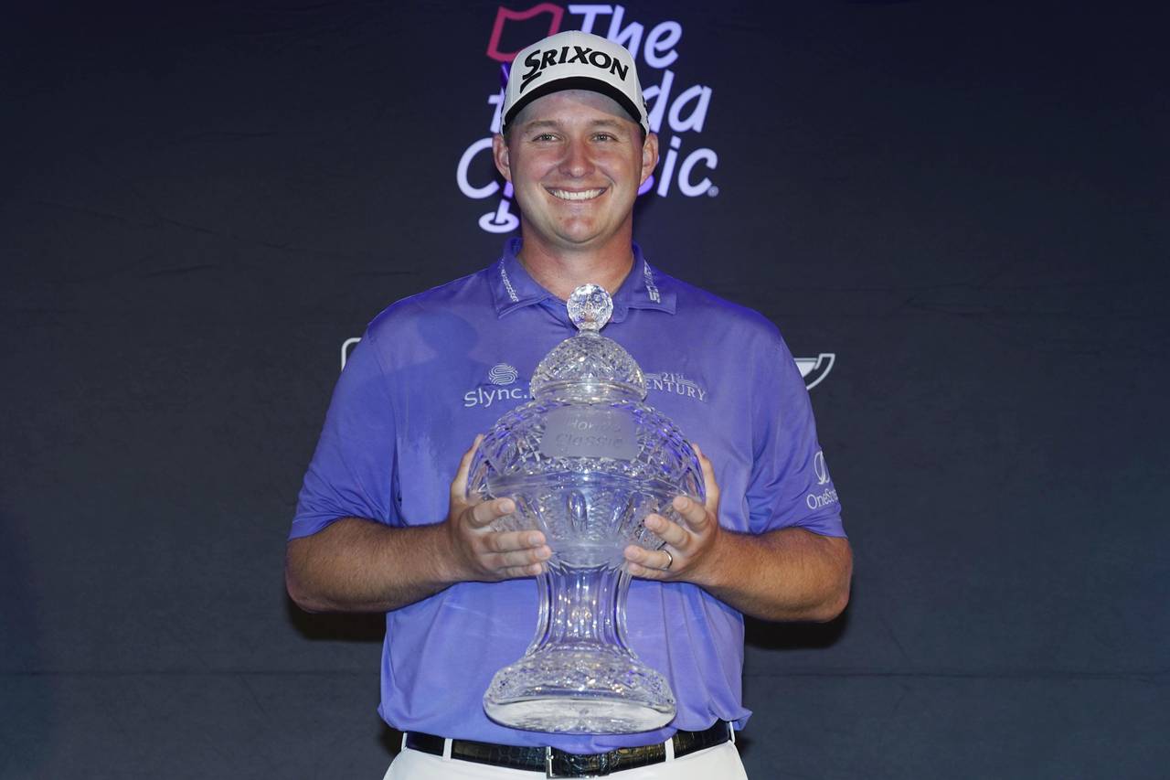 Sepp Straka, of Austria, holds the Honda Classic trophy after winning the final round of the golf t...