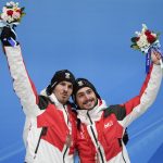 
              Thomas Steu and Lorenz Koller, of Austria, celebrate winning the bronze medal in the luge doubles at the 2022 Winter Olympics, Wednesday, Feb. 9, 2022, in the Yanqing district of Beijing. (AP Photo/Mark Schiefelbein)
            