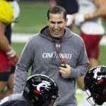
              FILE - Cincinnati head coach Luke Fickell directs his players during practice for the Cotton Bowl NCAA football game, on Dec. 27, 2021, in Arlington, Texas. The Bearcats ran the table in the American Athletic Conference and became the first team from a second-tier conference to reach the College Football Playoff, taking their only loss to No. 1 Alabama in a national semifinal. (AP Photo/Brandon Wade, File)
            