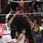 
              Stanford forward Harrison Ingram (55) takes a 3-point shot over California guard Jalen Celestine (32) during the second half of an NCAA college basketball game in Stanford, Calif., Tuesday, Feb. 1, 2022. Stanford won 57-50. (AP Photo/Tony Avelar)
            