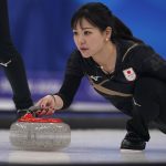 
              Japan's Chinami Yoshida throws a rock during the women's curling final match between Japan and Britain at the Beijing Winter Olympics Sunday, Feb. 20, 2022, in Beijing. (AP Photo/Brynn Anderson)
            