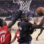 
              Los Angeles Clippers guard Reggie Jackson, right, shoots as Houston Rockets guard Dennis Schroder defends during the first half of an NBA basketball game Thursday, Feb. 17, 2022, in Los Angeles. (AP Photo/Mark J. Terrill)
            
