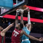 
              Charlotte Hornets guard LaMelo Ball (2) dunks over Miami Heat forward Haywood Highsmith (24) and guard Max Strus (31) during the first half of an NBA basketball game Thursday, Feb. 17, 2022, in Charlotte, N.C. (AP Photo/Matt Kelley)
            