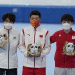 
              Gao Tingyu of China poses during a medal ceremony after winning the gold medal and setting an Olympic record in the men's speedskating 500-meter race at the 2022 Winter Olympics, Saturday, Feb. 12, 2022, in Beijing. Left is silver medalist Cha Min-kyu of South Korea and right is bronze medalist Wataru Morishige of Japan. (AP Photo/Ashley Landis)
            
