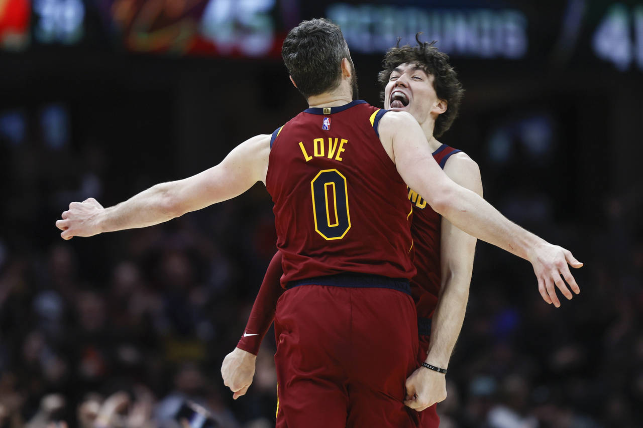 Cleveland Cavaliers' Cedi Osman (16) and Kevin Love (0) celebrate after a basket against the Indian...