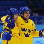 
              Sweden's Lucas Wallmark, left, celebrates with Henrik Tommernes after Hallmark scored a goal against Latvia during a preliminary round men's hockey game at the 2022 Winter Olympics, Thursday, Feb. 10, 2022, in Beijing. (AP Photo/Matt Slocum)
            