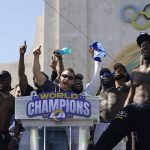 
              Los Angeles Rams head coach Sean McVay, center, reacts with players at Los Angeles Memorial Coliseum following the team's victory parade in Los Angeles, Wednesday, Feb. 16, 2022. The Rams beat the Cincinnati Bengals Sunday in the NFL Super Bowl 56 football game. (AP Photo/Marcio Jose Sanchez)
            