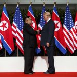 
              FILE - North Korean leader Kim Jong Un, left, and U.S. President Donald Trump shake hands prior to their meeting on Sentosa Island in Singapore on June 12, 2018. North Korea basked in the global limelight during the last Winter Games in South Korea, with hundreds of athletes, cheerleaders and officials pushing hard to woo their South Korean and U.S. rivals in a now-stalled bid for diplomacy. Four years later, as the 2022 Winter Olympics come to its main ally and neighbor China, North Korea isn't sending any athletes and officials because of coronavirus fears. (AP Photo/Evan Vucci, File)
            