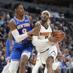 
              Denver Nuggets forward Will Barton, right, is defended by New York Knicks guard RJ Barrett during the second half of an NBA basketball game Tuesday, Feb. 8, 2022, in Denver. The Nuggets won 132-115. (AP Photo/David Zalubowski)
            