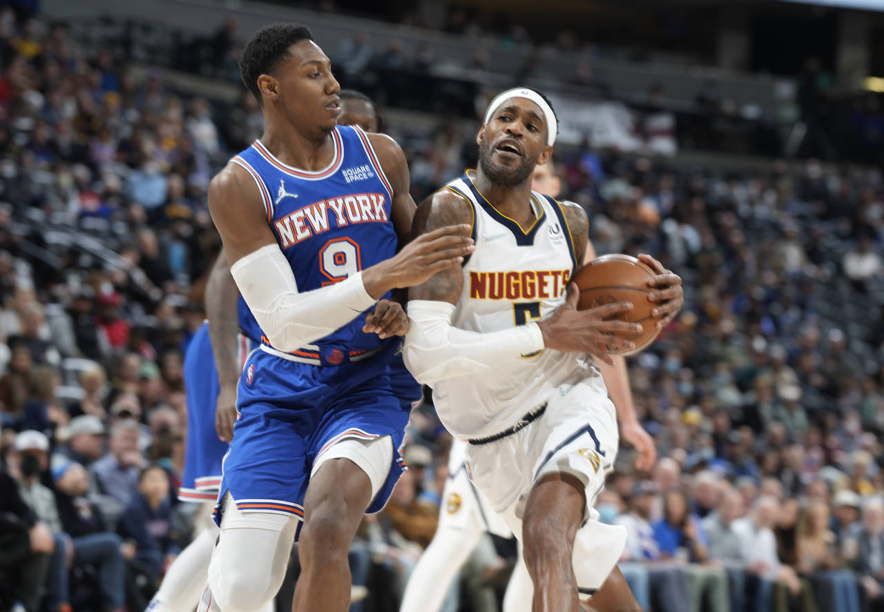 Denver Nuggets forward Will Barton, right, is defended by New York Knicks guard RJ Barrett during t...