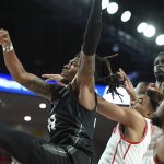 
              Central Florida forward C.J. Walker (21) watches his layup attempt as he falls back into the Houston defense during the first half of an NCAA college basketball game Thursday, Feb. 17, 2022, in Houston. (AP Photo/Justin Rex)
            