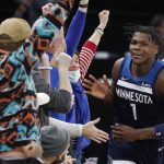 
              Minnesota Timberwolves forward Anthony Edwards celebrates his 3-pointer with fans in the last minute of an NBA basketball game against the Detroit Pistons, Sunday, Feb. 6, 2022, in Minneapolis. The Timberwolves won 118-105. (AP Photo/Bruce Kluckhohn)
            