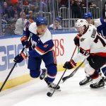 
              New York Islanders' Anders Lee (27) drives the puck against Ottawa Senators' Thomas Chabot (72) during the second period of an NHL hockey game Tuesday, Feb. 1, 2022, in Elmont, N.Y. (AP Photo/Jason DeCrow)
            