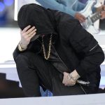 
              Eminem kneels down during the halftime performance at the NFL Super Bowl 56 football game between the Los Angeles Rams and the Cincinnati Bengals Sunday, Feb. 13, 2022, in Inglewood, Calif. (AP Photo/Chris O'Meara)
            