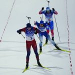 
              Johannes Thingnes Boe of Norway pulls ahead of Quentin Fillon Maillet of France, second, and Eduard Latypov of the Russian Olympic Committee at the finish line in first during the 4x6-kilometer mixed relay at the 2022 Winter Olympics, Saturday, Feb. 5, 2022, in Zhangjiakou, China. (AP Photo/Kirsty Wigglesworth)
            