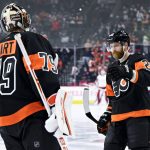 
              Philadelphia Flyers' Claude Giroux, right, high-fives Carter Hart after Giroux scored a goal during the first period of an NHL hockey game against the Washington Capitals, Saturday, Feb. 26, 2022, in Philadelphia. (AP Photo/Derik Hamilton)
            