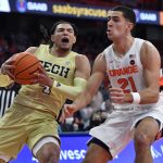 
              Georgia Tech guard/forward Jordan Usher, left, is defended by Syracuse forward Cole Swider during the first half of an NCAA college basketball game in Syracuse, N.Y., Monday, Feb. 21, 2022. (AP Photo/Adrian Kraus)
            