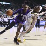
              TCU guard Okako Adika, left, fouls Baylor center Queen Egbo, right, while driving to the basket during the first half of an NCAA college basketball game Wednesday, Feb. 16, 2022, in Waco, Texas. (Rod Aydelotte/Waco Tribune-Herald via AP)
            