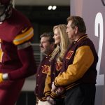 
              Dan, left, and Tanya Snyder, co-owner and co-CEOs of the Washington Commanders, stand with former quarterback Joe Theismann, right, after unveiling their NFL football team's new identity, Wednesday, Feb. 2, 2022, in Landover, Md. The new name comes 18 months after the once-storied franchise dropped its old moniker following decades of criticism that it was offensive to Native Americans. (AP Photo/Patrick Semansky)
            