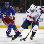 
              Washington Capitals' Alex Ovechkin (8) controls the puck while New York Rangers' Ryan Reaves (75) trails the play during the first period of an NHL hockey game Thursday, Feb. 24, 2022, in New York. (AP Photo/John Munson)
            
